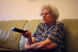 Woman with macular degeneration, watching TV