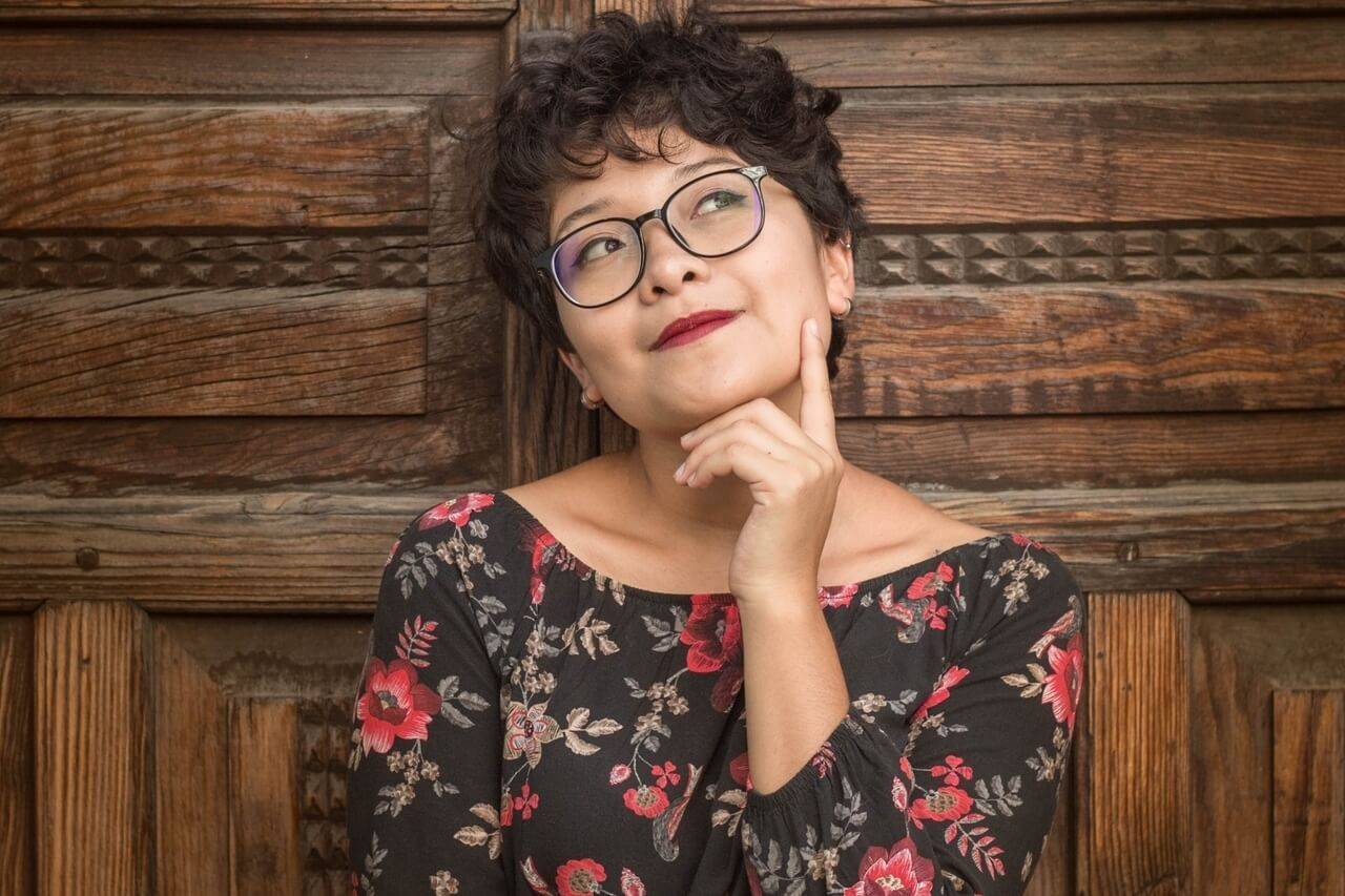 Woman with eyeglasses, in thought