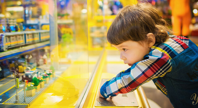 child looking at toys 640