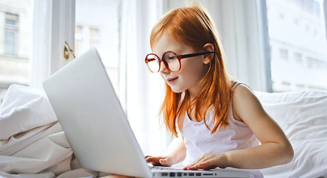 Girl on laptop wearing glasses