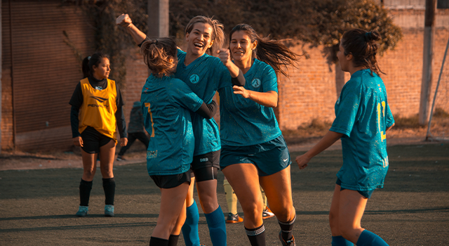 Women on a soccer team celebrating